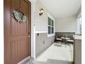 Cozy front porch with wreath, seating, and welcoming ambiance, ideal for relaxation at 13730 Bravante Aly, Windermere, FL 34786