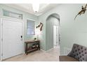 Inviting home foyer with neutral color palette, tile floors, and decorative fish art at 15506 Tidal Cove Aly, Winter Garden, FL 34787