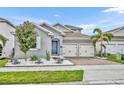 Charming two-story home with a two-car garage, blue door, and a well-manicured yard at 16259 Misty Hills Ave, Winter Garden, FL 34787