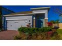 Eye-catching single-Gathering home with brick driveway, an attached two-car garage, and beautiful front yard foliage at 1740 Deans Crossing Ln, Orlando, FL 32825