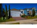 Attractive single-Gathering house boasting a brick driveway, two-car garage, and lush landscaping at 1740 Deans Crossing Ln, Orlando, FL 32825