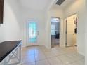 Bright foyer with tile flooring, a decorative glass front door, and views into other rooms at 209 Silver Maple Rd, Groveland, FL 34736