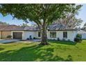 Charming single-story home featuring a well-maintained lawn, a two-car garage, and a modern front door at 2294 Lakeview Ave, Clermont, FL 34711