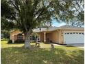 Charming single-story home featuring a well-maintained lawn and an attached two-car garage at 231 Cranbrook Dr, Kissimmee, FL 34758