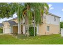 Side view of a charming two-story home with manicured landscaping and a well-kept lawn at 2362 Blossomwood Dr, Oviedo, FL 32765