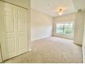 Spacious carpeted bedroom with ample closet space and natural light streaming through the window at 2605 Gala S Rd # 103, Kissimmee, FL 34746