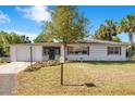 Beautiful single-story home with lush landscaping, an attached garage, and a quaint mailbox at 33 Sunset Dr, Debary, FL 32713