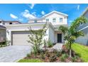 Charming two-story home with a two-car garage and manicured front yard landscaping at 3373 Lilac Way, Davenport, FL 33897