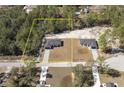 Aerial view of two homes with gray roof and driveway surrounded by lush green trees at 41915 Aspen St, Eustis, FL 32736