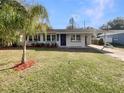 Charming single-story home with a well-manicured lawn and attached carport at 4270 Solomon Dr, Orlando, FL 32811