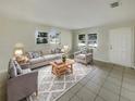 Inviting living room with neutral paint, tile floors, and natural light at 4270 Solomon Dr, Orlando, FL 32811