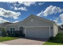 Single story home with gray exterior, gray stone accent and two car garage at 4317 Deleon St, Haines City, FL 33844