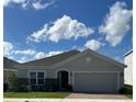 Single story home with gray exterior, gray stone accent and two car garage at 4317 Deleon St, Haines City, FL 33844