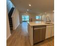 Kitchen with island, stainless steel appliances, and a view of the living area at 4972 Lyric Dr, Mascotte, FL 34753