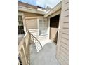 This tan-colored balcony includes access to stairs, a window, and the unit's front door at 615 Richland Ct # 66, Altamonte Springs, FL 32714