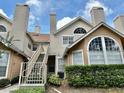 Traditional-style two-story condominiums with neutral colors, stairs, and well-maintained shrubbery at 615 Richland Ct # 66, Altamonte Springs, FL 32714