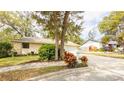 Charming one-story home featuring a well-manicured lawn, mature trees, and a two-car garage at 690 Shady Ct, Altamonte Springs, FL 32701