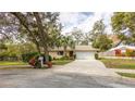 Charming single-story home with a well-manicured lawn, mature trees, and a long driveway at 690 Shady Ct, Altamonte Springs, FL 32701