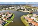 Aerial view of a waterfront community with manicured lawns and backyard docks on a beautiful lake at 890 Spinnaker Way, Kissimmee, FL 34746