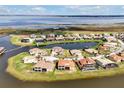 Aerial view of homes and community with waterway access and beautiful landscaping around the property at 890 Spinnaker Way, Kissimmee, FL 34746