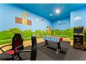 Fun game room with Super Mario Brothers themed walls, foosball table, and Street Fighter II arcade at 8900 Candy Palm Rd, Kissimmee, FL 34747