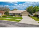 Traditional home boasting well-kept landscaping, a spacious driveway, and an attached two-car garage at 105 Lena Ann Dr, St Cloud, FL 34771