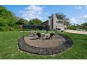 Inviting backyard with a stone fire pit, seating, and well-maintained lawn, perfect for outdoor gatherings at 1606 Wildcat Ct, Winter Springs, FL 32708