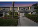 Charming two-story townhome at twilight with attached garage, landscaped yard, and well-maintained exterior at 2080 Switch Grass Cir, Ocoee, FL 34761