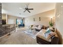 Comfortable living room with plush seating, stylish decor, ceiling fan, and lots of natural light at 2080 Switch Grass Cir, Ocoee, FL 34761