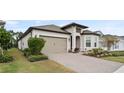 Beautiful single-story home featuring a paver driveway and a neatly landscaped front yard at 2116 Limestone Trl, Kissimmee, FL 34747