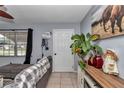 Comfortable living room with neutral color walls, tile flooring, an adjacent cabinet, and a large window at 2833 Ne 18Th Ct, Ocala, FL 34470