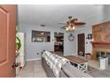 Comfortable living room with a fireplace, neutral color walls, tile flooring, and plenty of natural light at 2833 Ne 18Th Ct, Ocala, FL 34470