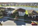 Aerial view of homes near a lake, showcasing the desirable neighborhood and waterfront views at 3854 Carrick Bend Dr, Kissimmee, FL 34746