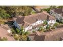 Overhead view of a complex of townhomes with landscaping and a mix of roofs and trees at 5354 Diplomat Ct # 106, Kissimmee, FL 34746