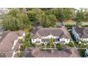 Aerial view showcases the townhomes' layout and proximity to a treed park and road at 5354 Diplomat Ct # 106, Kissimmee, FL 34746