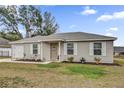 Charming single-story home with manicured lawn, a front-facing garage and inviting front porch at 10 Pine Course Pass, Ocala, FL 34472