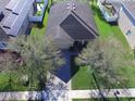 An aerial view of the single-Gathering home, featuring well-maintained landscaping and a brick paved driveway at 1107 Galway Blvd, Apopka, FL 32703