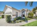 Stucco home featuring a large arched window, lush landscaping, and a serene fountain at 11278 Papyrus Ln, Orlando, FL 32821