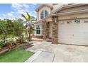 Inviting front entrance with brick accents, manicured landscaping, and a well-maintained walkway leading to the front door at 12100 Calaboose Ct, Orlando, FL 32828