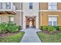 Inviting entryway featuring landscaped grounds leading to a covered walkway at 1211 Stonecutter Dr # 304, Celebration, FL 34747