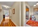 Arched doorway leading into the kitchen, with hardwood floors, and neutral walls at 1211 Stonecutter Dr # 304, Celebration, FL 34747