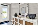 Bright foyer with shiplap accent wall and stylish white cabinet at 2801 Jamaica Way, Haines City, FL 33844