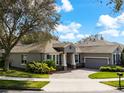 Beautiful single-story home featuring a brick driveway, attached garage and lush landscaping at 2856 Park Meadow Dr, Apopka, FL 32703