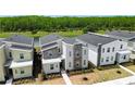 Overhead view of modern homes near a tranquil lake and lush green forest at 2904 Penelope Loop, Kissimmee, FL 34746