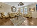 Elegant living room featuring hardwood floors, neutral tones, shuttered windows, and stylish decor at 3909 Messina Dr, Lake Mary, FL 32746