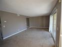 Bright living room with carpet, fresh paint and sliding glass door at 4109 Dijon Dr # 4109H, Orlando, FL 32808