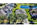 Aerial view of the home showcasing its backyard, screened in pool, and view of the nearby pond at 472 Huntington Pines Dr, Ocoee, FL 34761