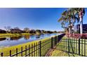 View of the fenced backyard with a pond view at 472 Huntington Pines Dr, Ocoee, FL 34761