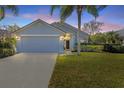 Charming single-story home features a well-manicured lawn and an attached two-car garage at 515 Mickleton Loop, Ocoee, FL 34761