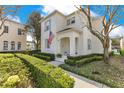 Beautiful two-story home with well-maintained landscaping, trimmed hedges, and a classic facade. The American flag adds a touch of patriotism at 5238 Baskin St, Orlando, FL 32814